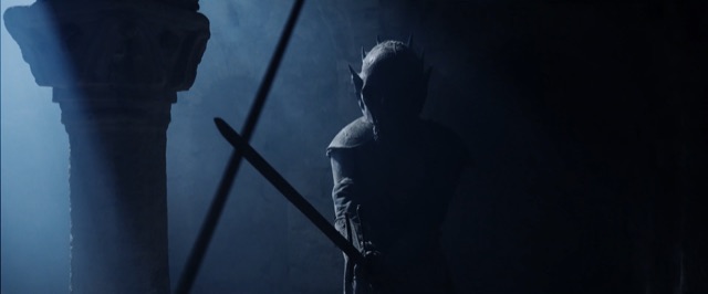 The Juggernaut knight with sword raised in a dark cloister