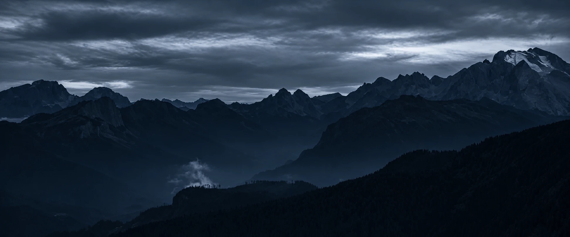 A lone knight dragging a sword up a misty hill under a pale sun